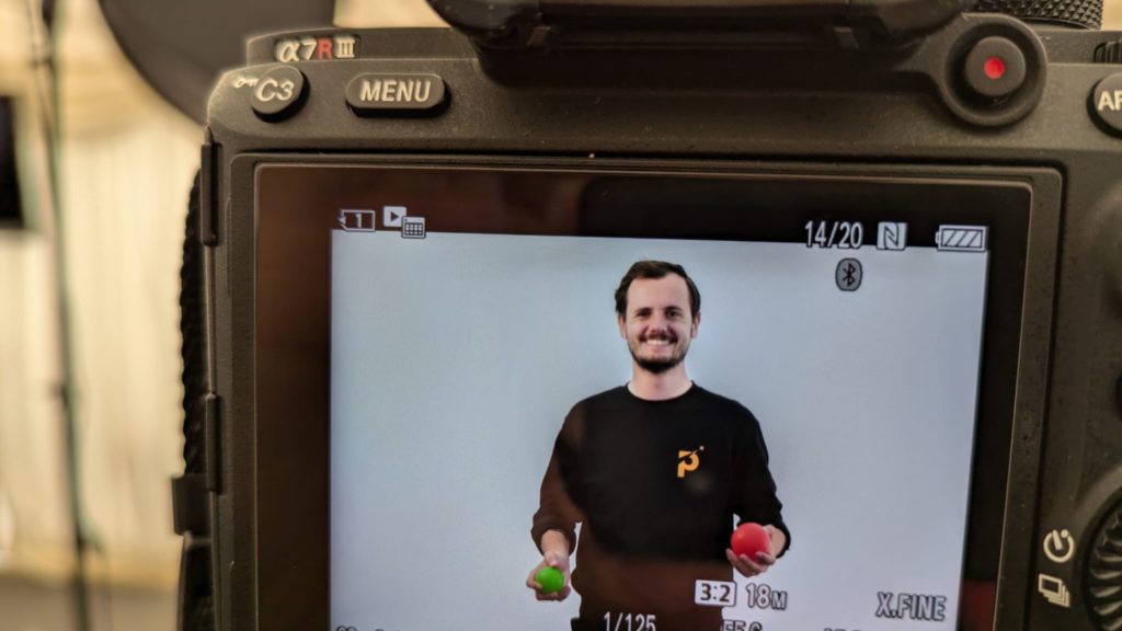 DSLR camera open with image of Joe juggling on the screen