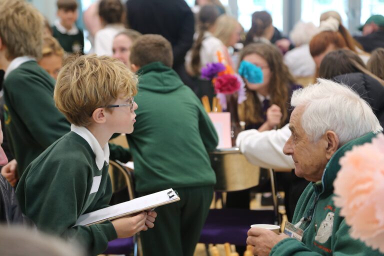 A young boy engaged in conversation with an older man.