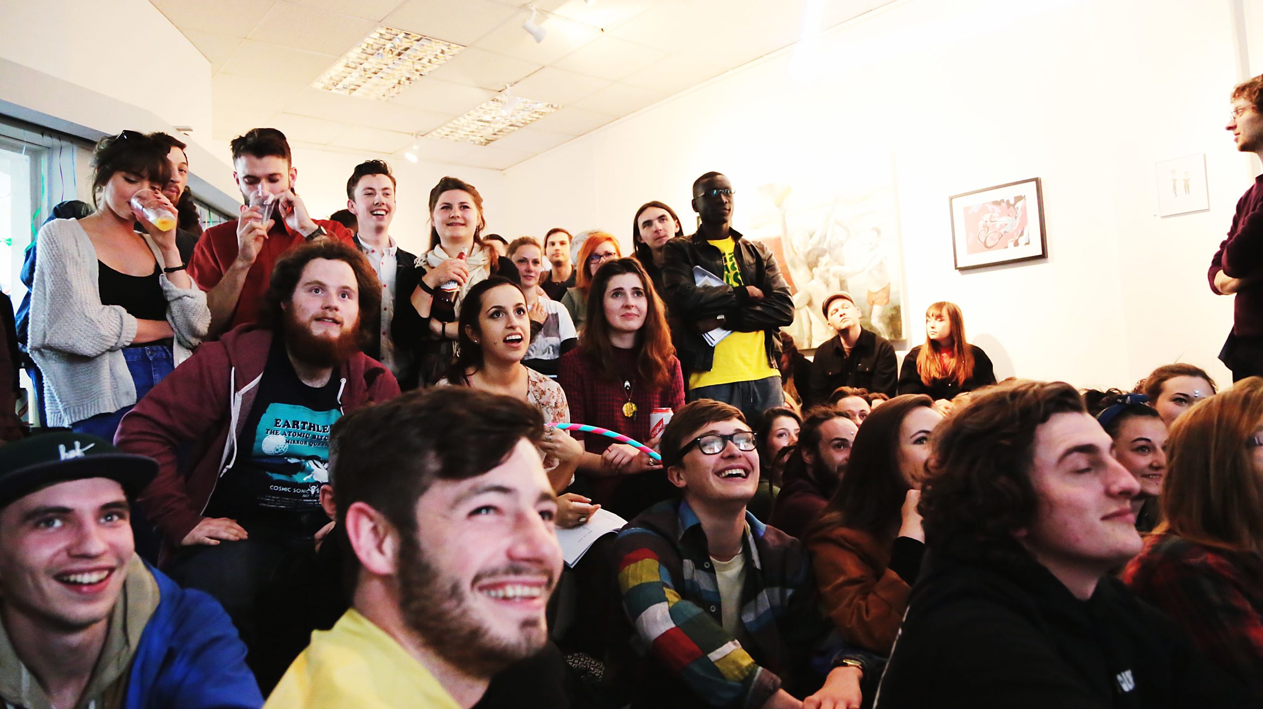 Group of people looking at a performer who is out of the photo.