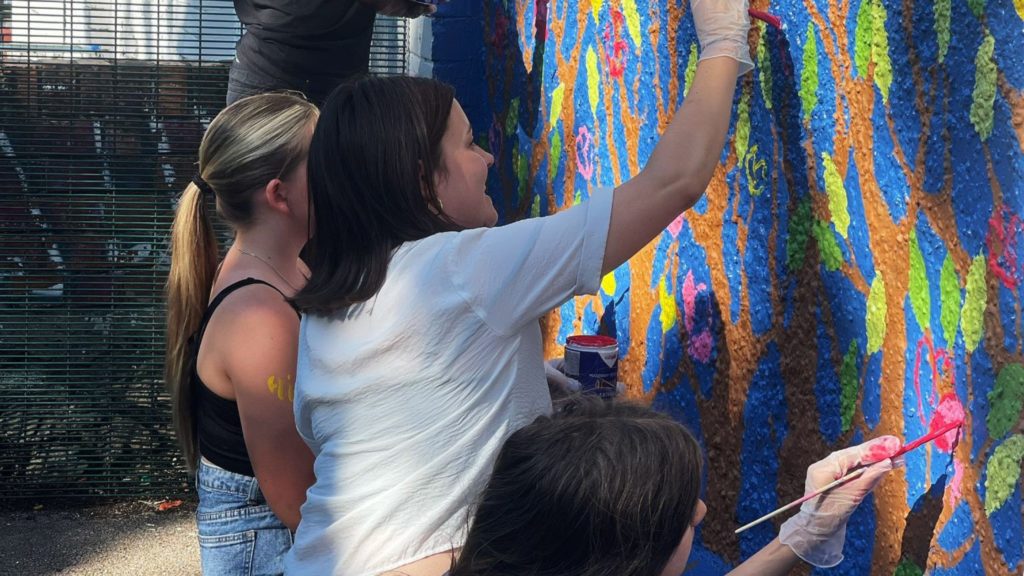 Young people from North Ely Youth Club painting the mural