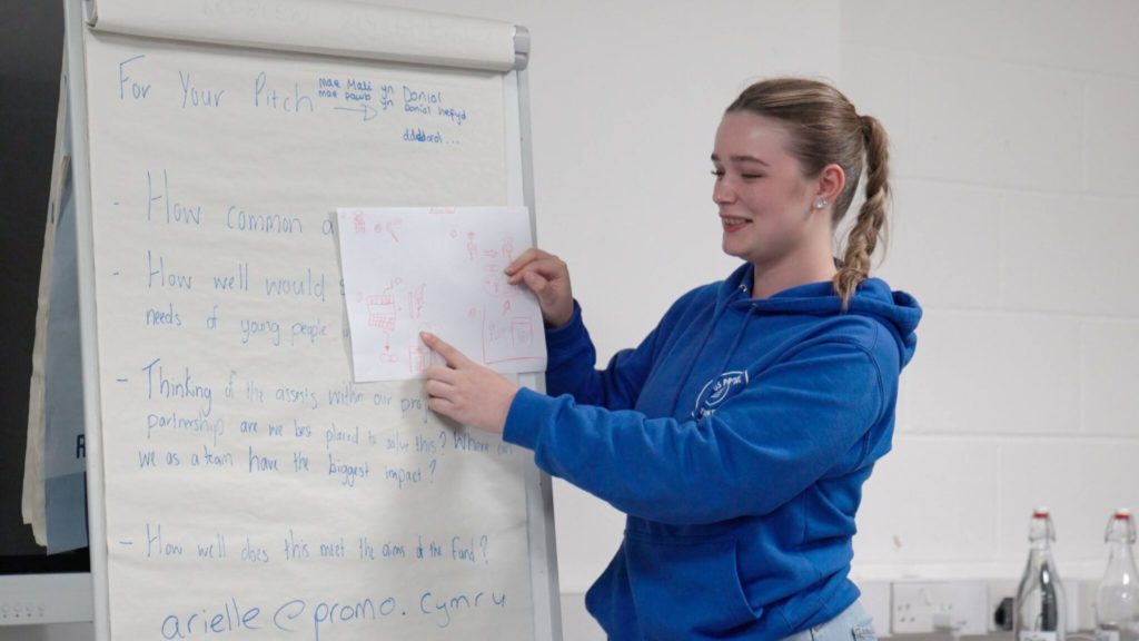 Young person presenting using flipchart paper