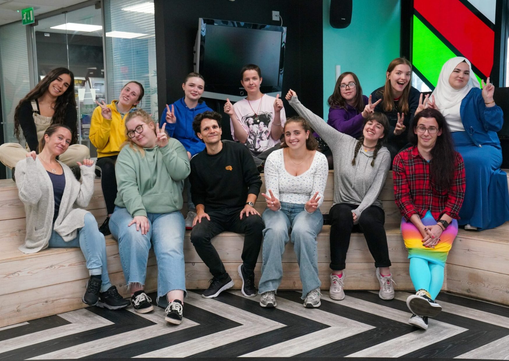 Group photograph of Mind Our Future Gwent peer researchers and staff, all looking happy and pulling funny faces.