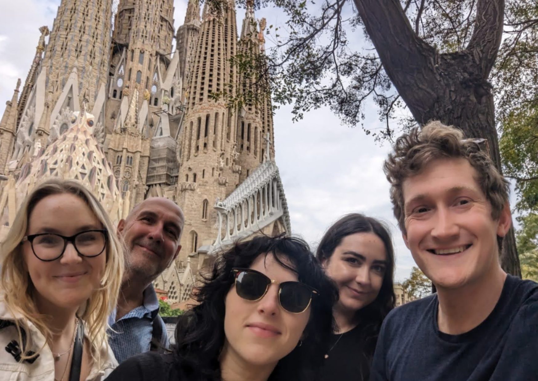 Five staff members stood in front of La Sagrada Familia