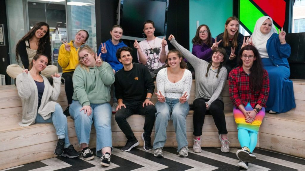 Group photo of staff and young people all pulling funny faces