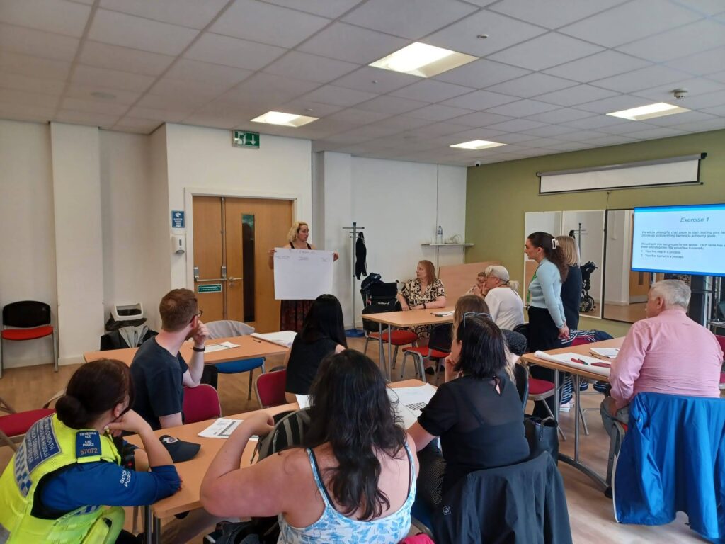 Group of professionals sat in a room during a workshop