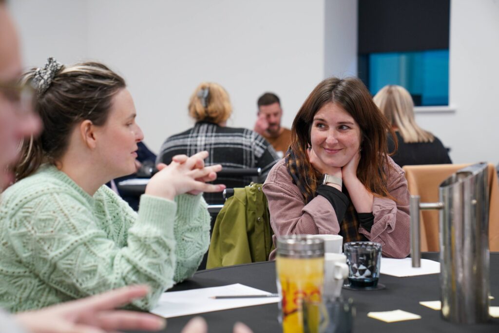 Stakeholders sat around a table, listening to ideas from young people