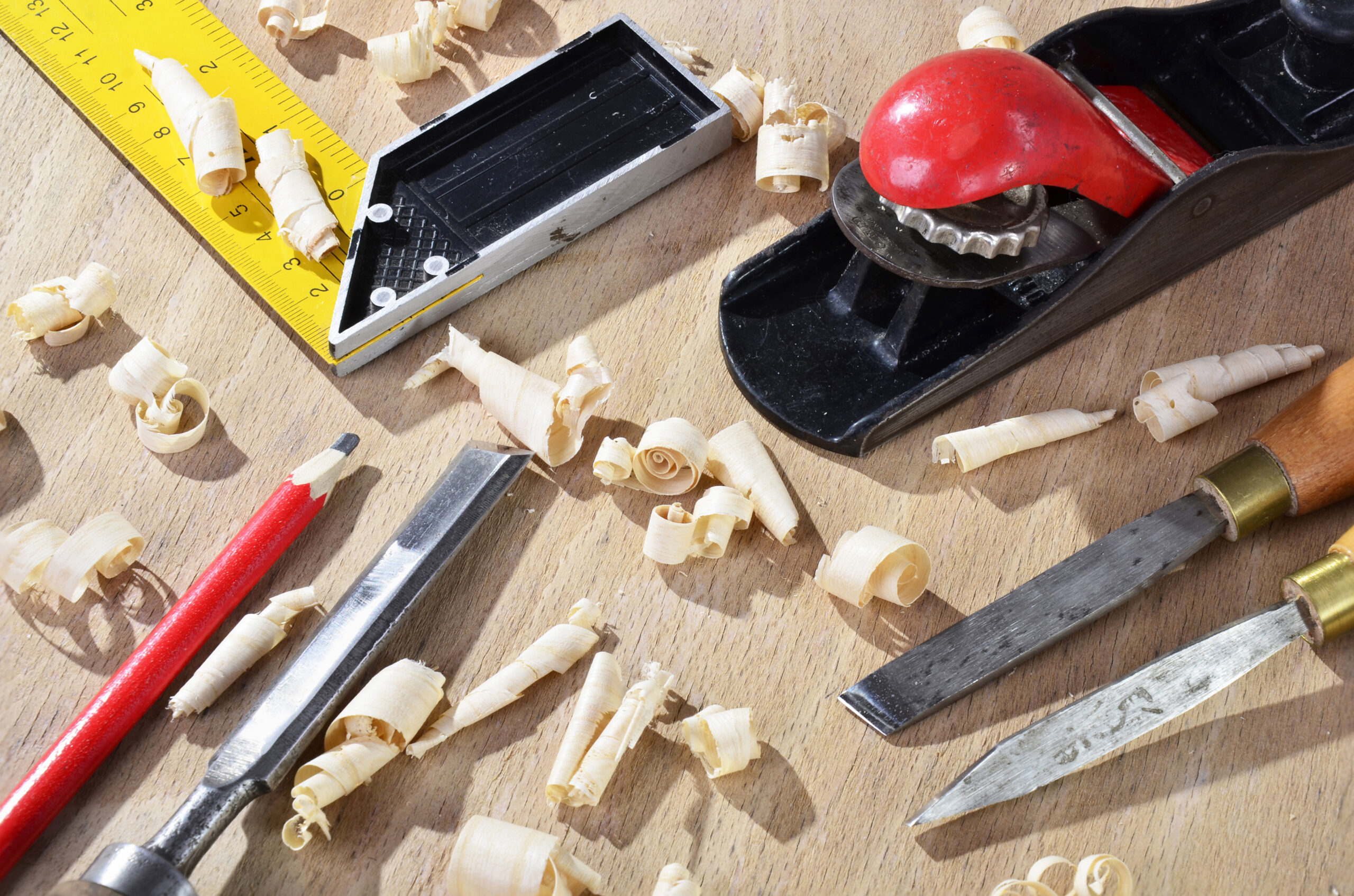High angle view of tools and wood shavings on table