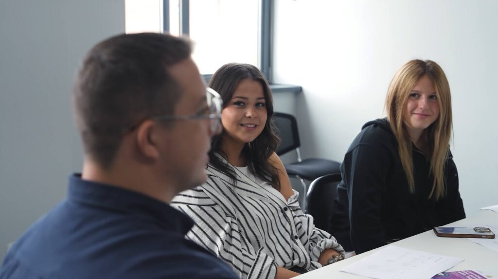 Young people and professionals working together around a table