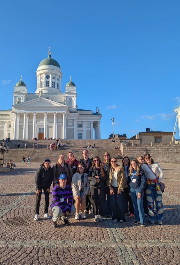 Group photo outside a beautiful building in Helsinki